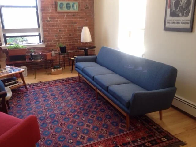 Modern blue sofa after custom reupholstery.