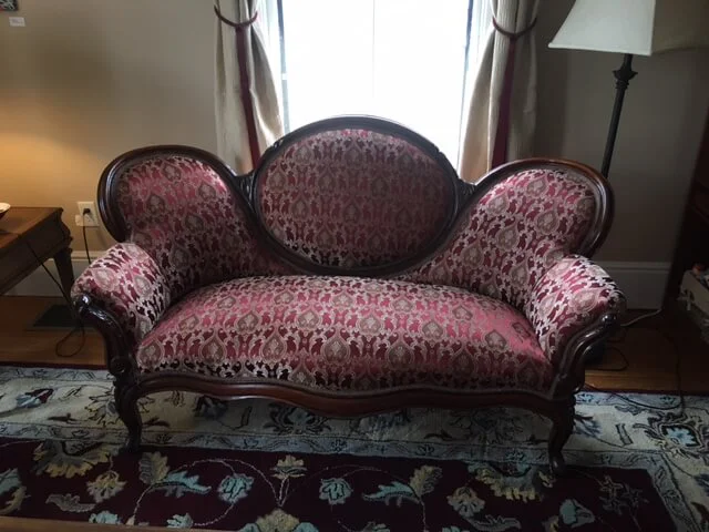 Our professional reupholstery services restored this antique red sofa